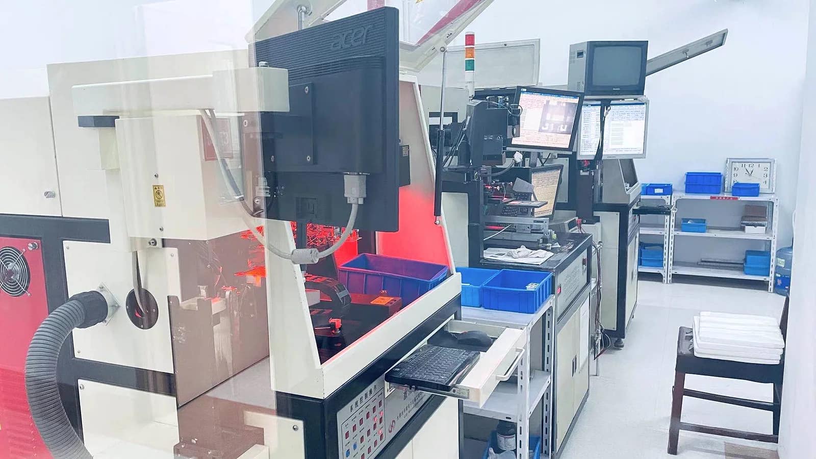 Company-source photograph of enclosed laser-processing equipment in the Dongguan workshop
